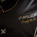Close-up of a black bag with 'IMPULSE LINE' branding and text.