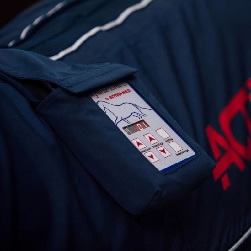 ActivoMed control box on navy blue blanket with red branding 