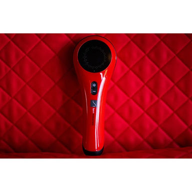 Red handheld 3b cold laser on a red quilted surface