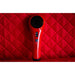 Red handheld 3b cold laser on a red quilted surface