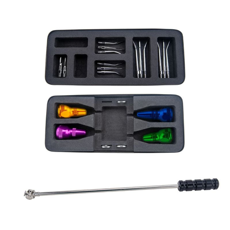 A 5-in-1 tattoo pen kit shown with its black foam storage case and included tools on a white background. The kit includes a silver metal pen with a black handle, four colorful anodized tip attachments in orange, yellow, blue, and green, and several silver needle cartridges.