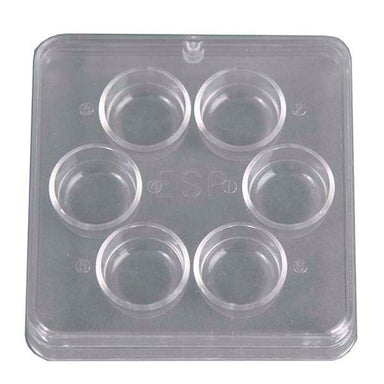 Clear plastic mold with six circular cavities on a white background