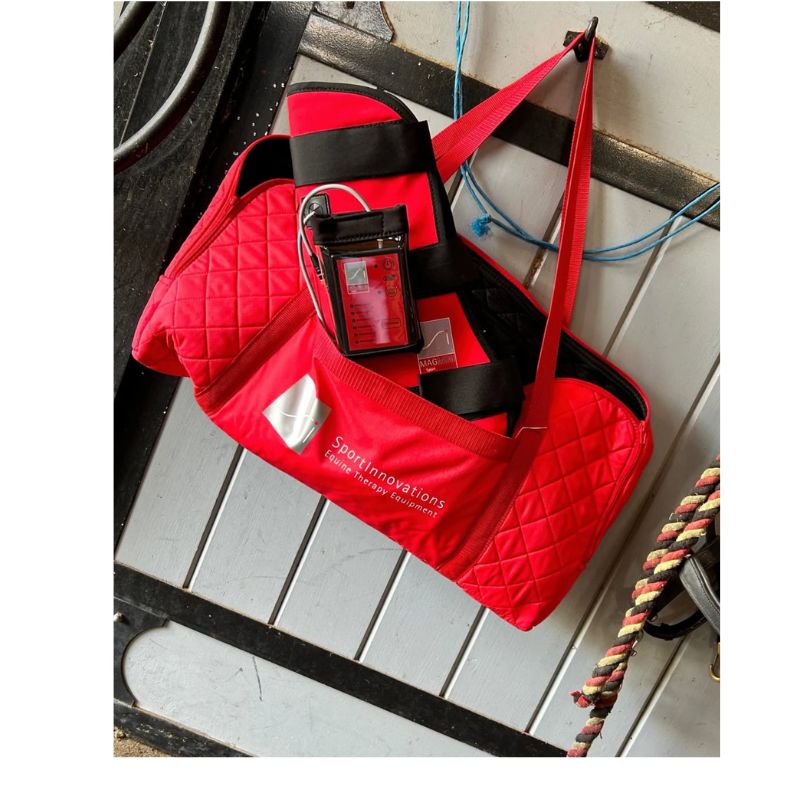 Sport Innovations Red bag with visible branding on a wooden surface