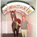 Man standing next to a horse under a large equine solarium