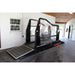 Equine treadmill in a garage setting with ramps and q-line branding in orange