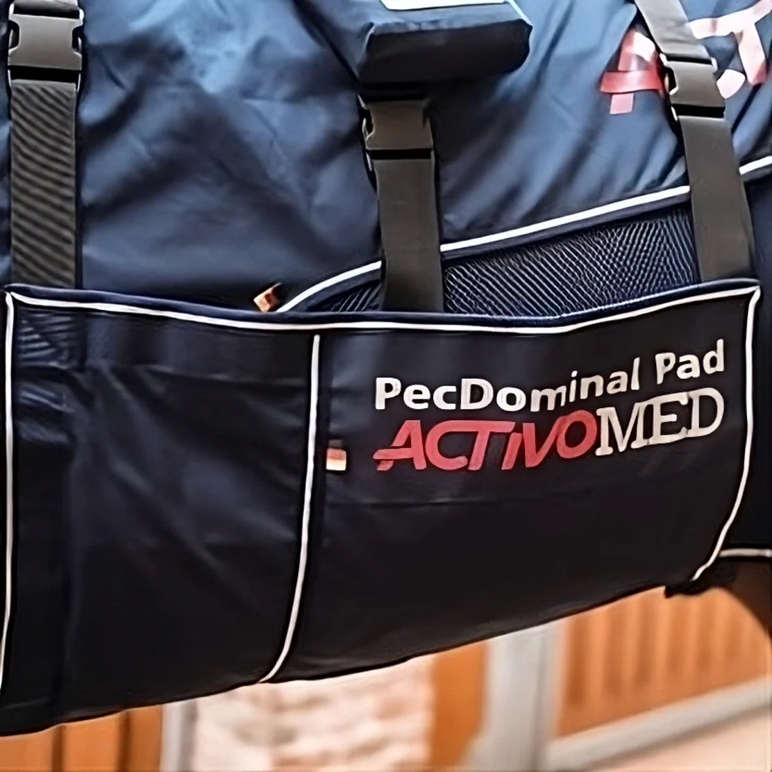 Navy blue bag with 'PecDominal Pad' and 'ActivoMed' branding on a blurred background