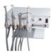A white dental operatory unit with multiple handpieces, hoses, and control knobs on a white background. The front panel shows the brand name NOVA DENT.