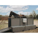 Horse in a large metal treadmill in an outdoor setting with trees and sky.