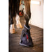 Horse leg with protective boot on a stable floor