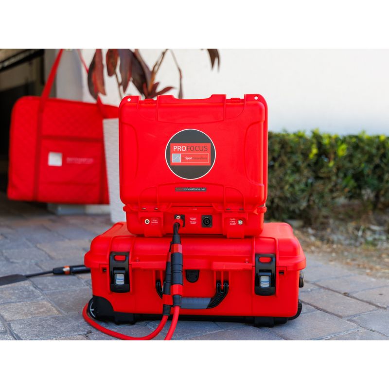 Red portable power station with a cable on a paved surface