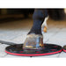 Horse hoof on a black and red hoof boot with a blurred background