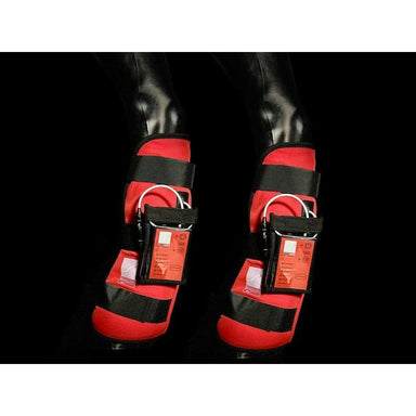 Red PEMF leg wraps for horses with black straps on a dark background