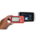 A hand holds a red Vetcordes handheld ECG monitor in the foreground, with a larger white and black Vetcordes monitor in the background showing a screen with heart rate readings.