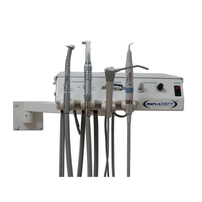 A dental operatory wall unit with multiple handpieces and gray tubing, mounted on a white wall. The control box has the Novacent logo on the front right.