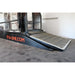 treadmill black ramp with a gray surface on a concrete floor, featuring 'Q-Line.com' branding.