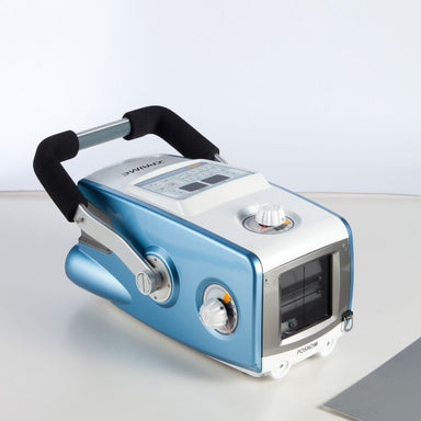 Blue and white handheld device with digital display on a light gray background