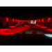 Red-lit interior of a stable with dark walls and floor.