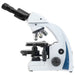 White and blue compound microscope on a white background