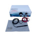 A professional tattoo ink mixing and dispensing machine kit, featuring a white and blue control box, a black mixing cup with red and black wires, several fine needle tips on a gray cloth, and a gray cleaning cloth, all set against a plain white background.